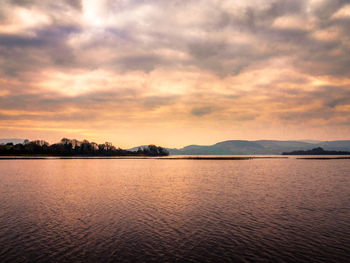 Scenic view of lake against sky during sunset