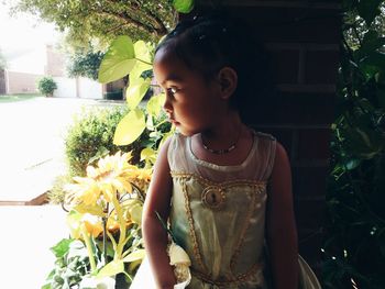 Close-up portrait of beautiful woman against trees