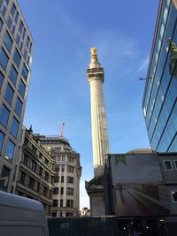 Low angle view of buildings against blue sky