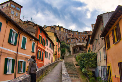 Street amidst buildings in city against sky