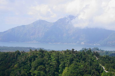 Scenic view of trees and mountains against sky, batur