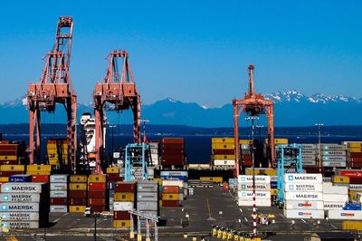 Commercial dock by sea against blue sky