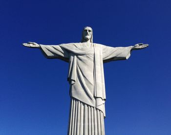 Low angle view of christ the redeemer against clear blue sky