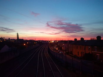 Railway tracks against sky during sunset