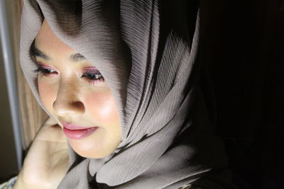 Close-up of young woman wearing hijab looking away