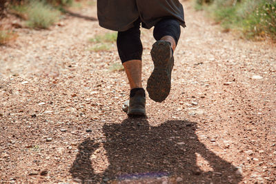 Low section of man running on ground