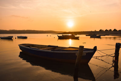 Boats in marina at sunset