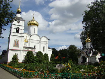Church by building against sky