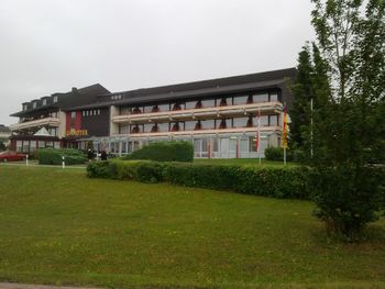 Lawn by building against sky