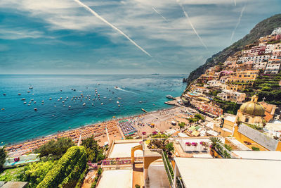 High angle view of townscape by sea against sky