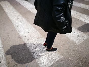 Low section of woman walking on floor