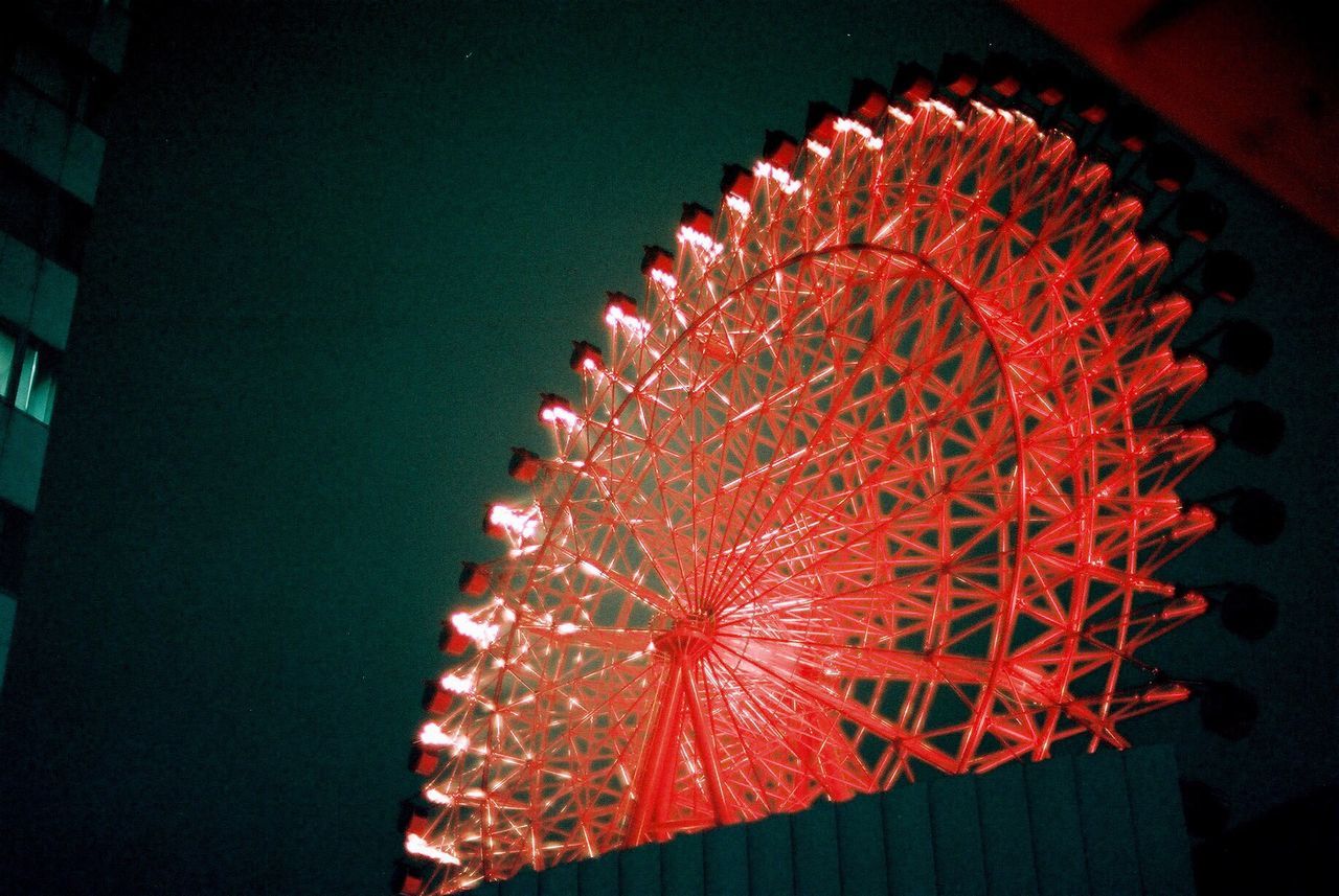 red, low angle view, night, illuminated, arts culture and entertainment, celebration, pattern, decoration, sky, tradition, ferris wheel, outdoors, no people, amusement park, close-up, amusement park ride, star shape, built structure, clear sky