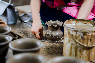 Midsection of woman making flower pot