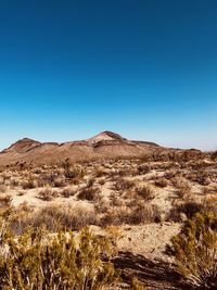 Low angle view of rock formations against clear blue sky