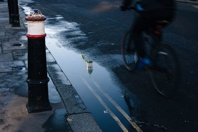 Reflection of bicycle in puddle