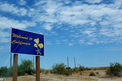 Road sign against blue sky