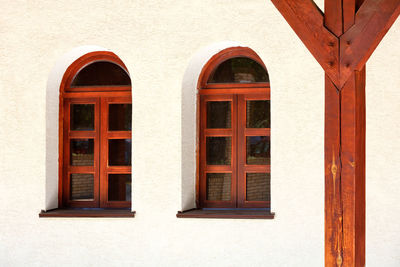 View of the terrace of an old ukrainian rural hut with antique arched windows, wooden support post.