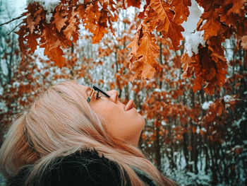 Portrait of woman with autumn leaves