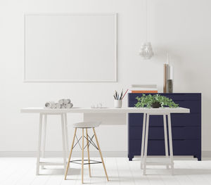 Empty chairs and table against wall at home