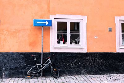 Bicycle parked against building