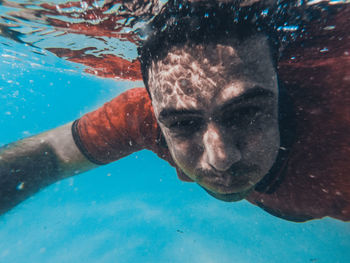 Portrait of man swimming in pool