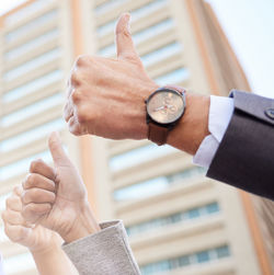 Cropped hand of businessman giving key