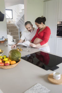 Man and fruits on table at home