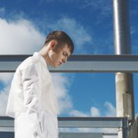 blue, railing, sky, lifestyles, waist up, leisure activity, focus on foreground, standing, low angle view, day, person, casual clothing, cloud, three quarter length, window, childhood, side view, cloud - sky