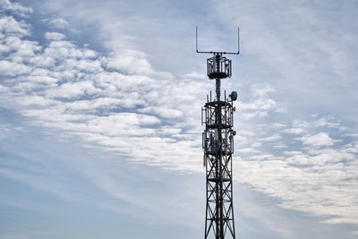 Low angle view of communications tower against sky