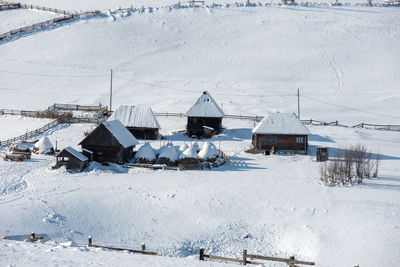 High angle view of houses on snow covered field