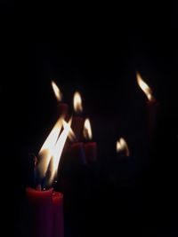 Close-up of burning candle in darkroom