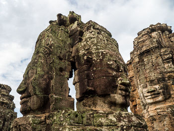 Low angle view of cross on rock