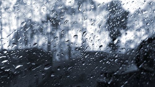 Full frame shot of wet glass window in rainy season