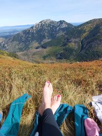 Low section of woman relaxing on mountain