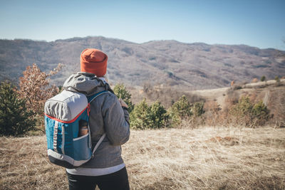 Rear view of man standing on land