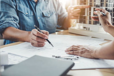 Midsection of man working on table