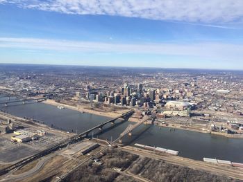 High angle view of cityscape against cloudy sky