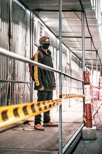 Man standing on railing