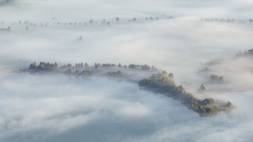 High angle view of fog covered land against sky
