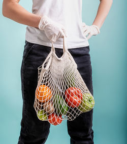 Midsection of woman standing against white background