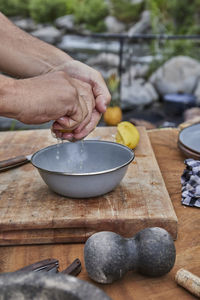 Chef squeezing lemon at campsite barbecue