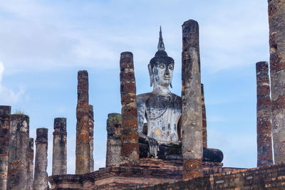 Panoramic view of statue of temple against buildings