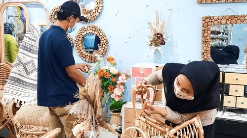 Midsection of friends standing at market stall