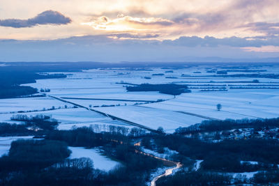 Scenic view of landscape against sky during winter