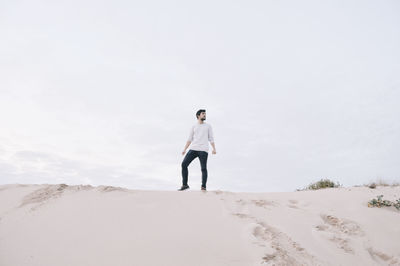 Full length of woman standing on sand