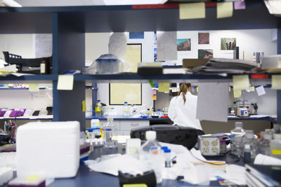 Rear view of female scientist working in laboratory