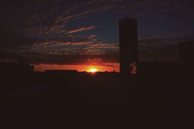 Silhouette of built structures at sunset