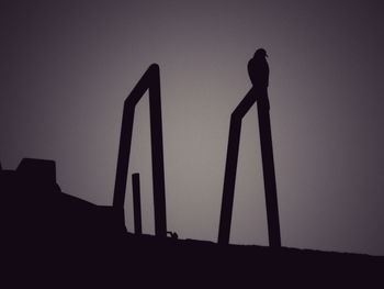 Low angle view of silhouette against clear sky