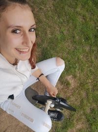 Portrait of a smiling young woman on field