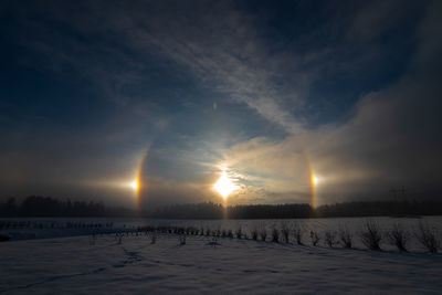 Scenic view of snow covered landscape against sky during sunset